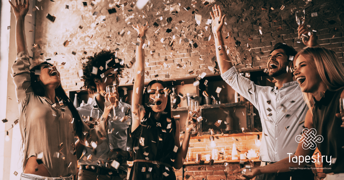 Group of friends throwing confetti into the air