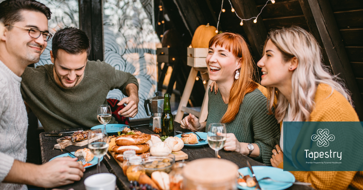 Group of friends sitting around enjoying a meal