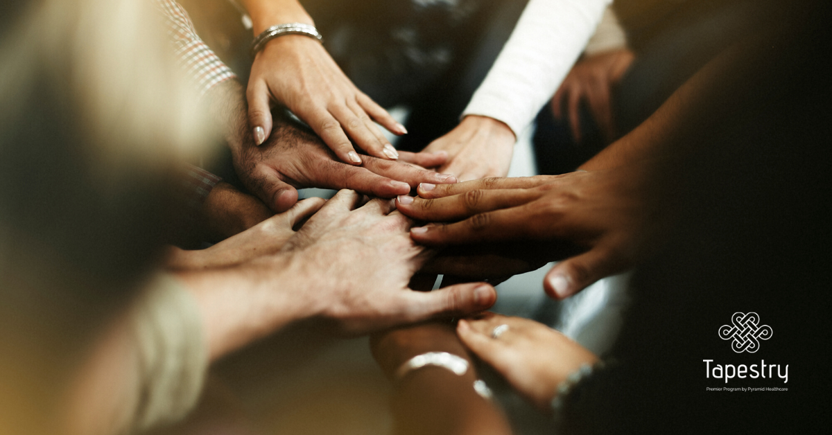 Group of people putting there hands in like a team