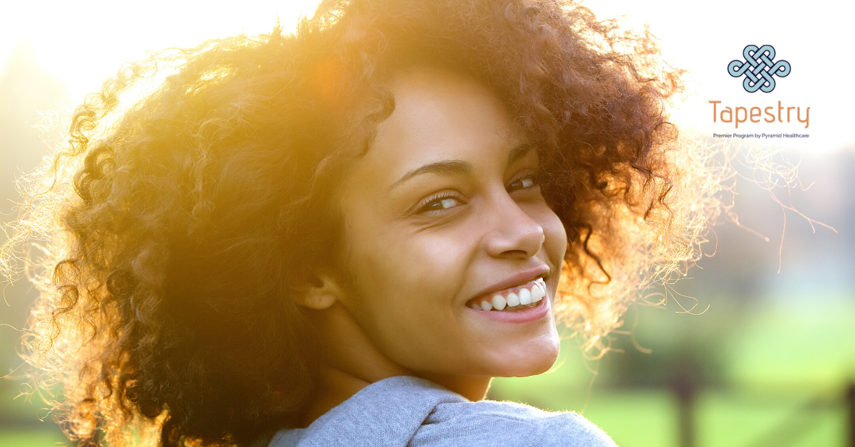 Young adult woman looking back at the camera and smiling