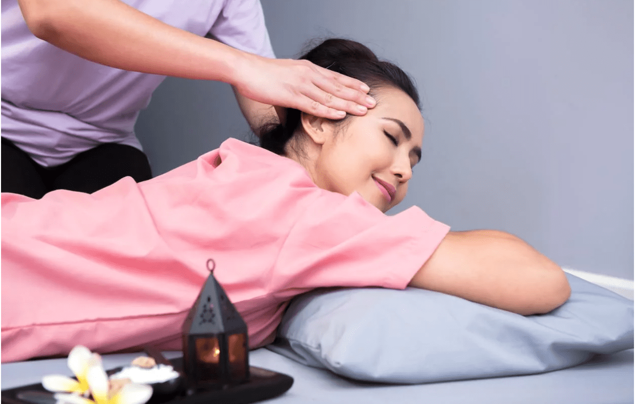 Woman laying down on her stomach getting a massage