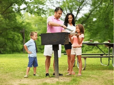 Family grilling out in the park