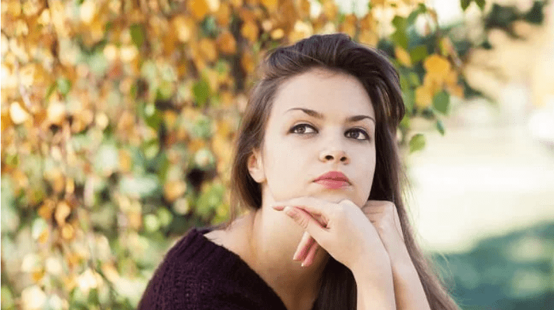 Young adult woman seriously looking off