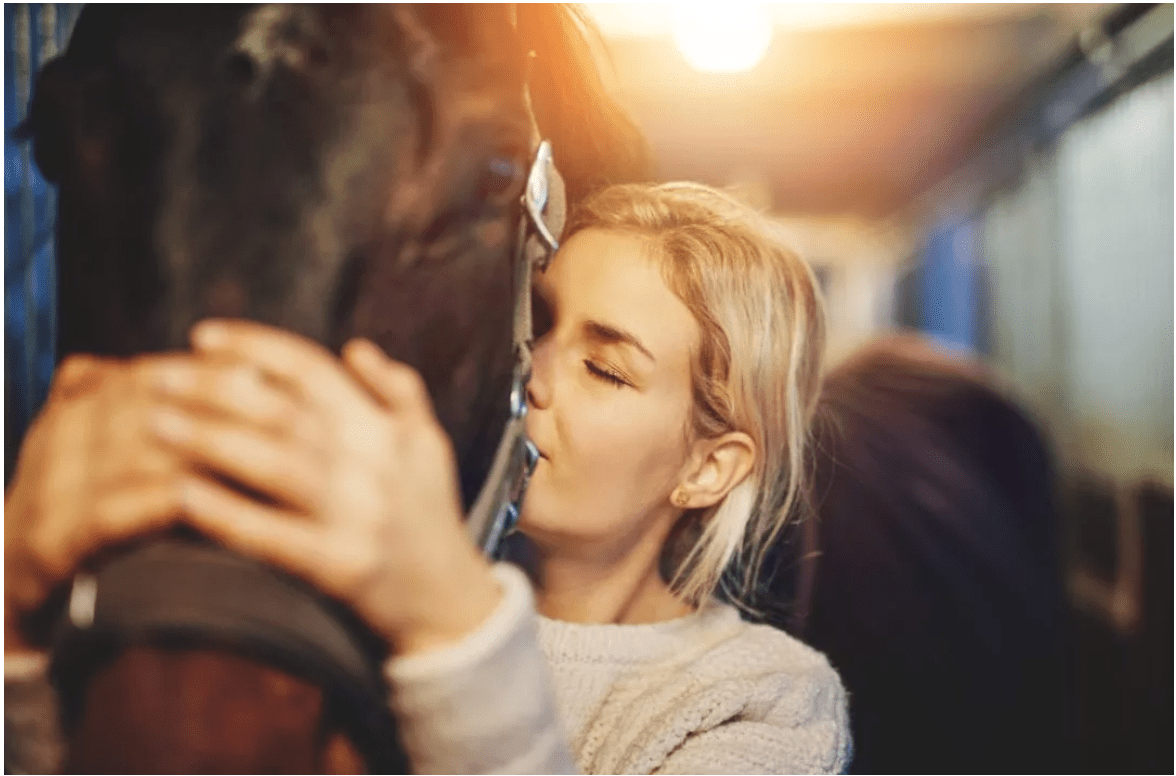 Woman petting a horse