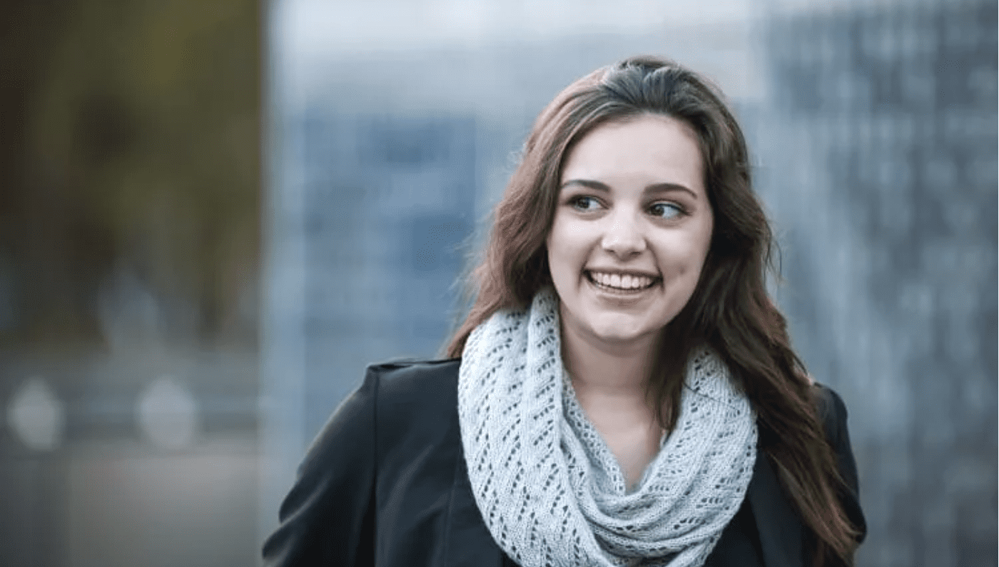 Young woman smiling while looking off to the side