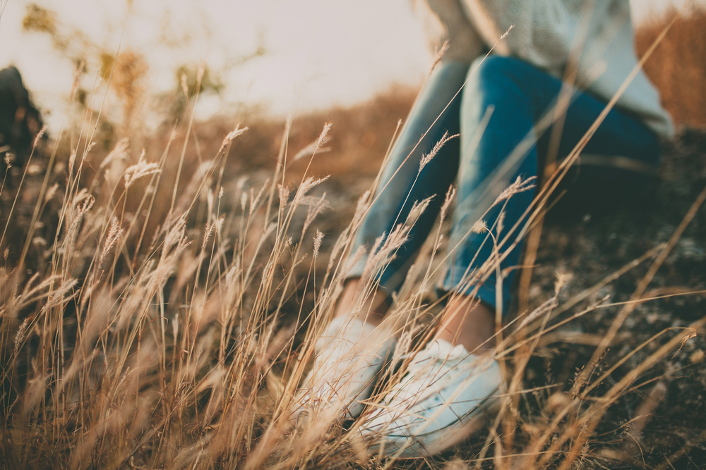 Young woman sitting in a field