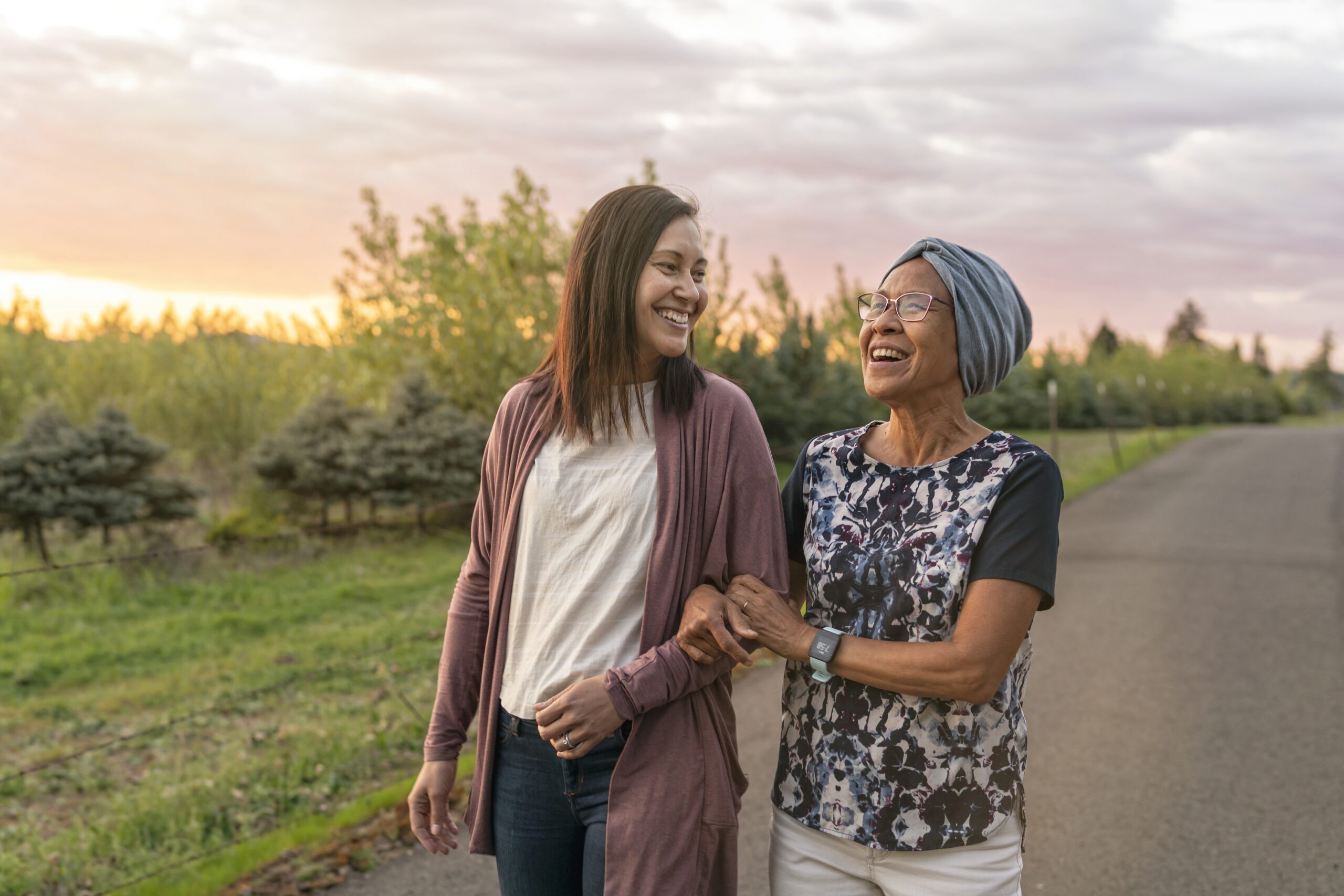 Woman with cancer walks with daughter outside