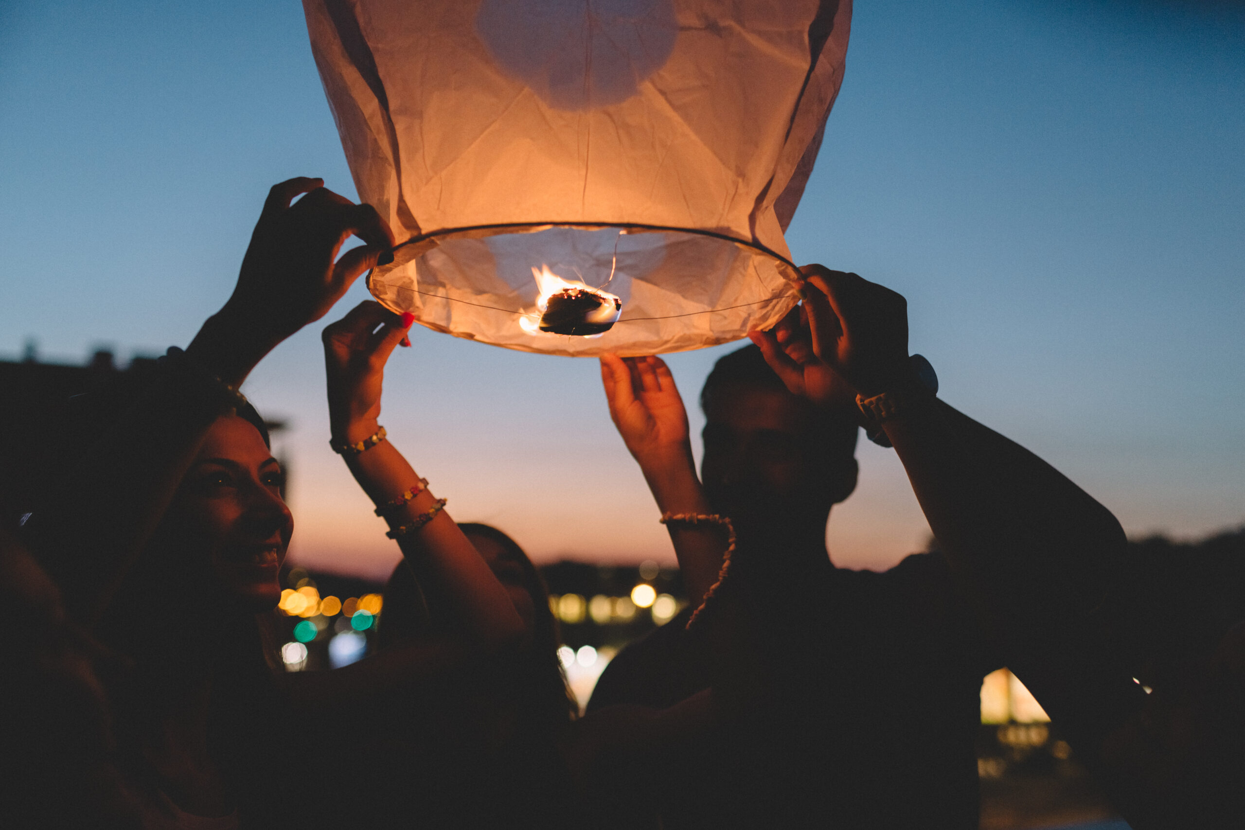 Group of friends releasing a chinese lantern