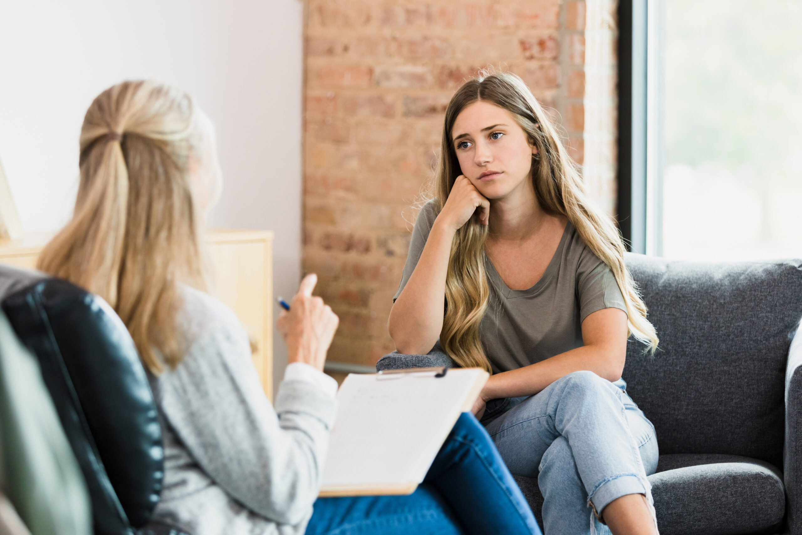 A psychologist speaking with a young woman