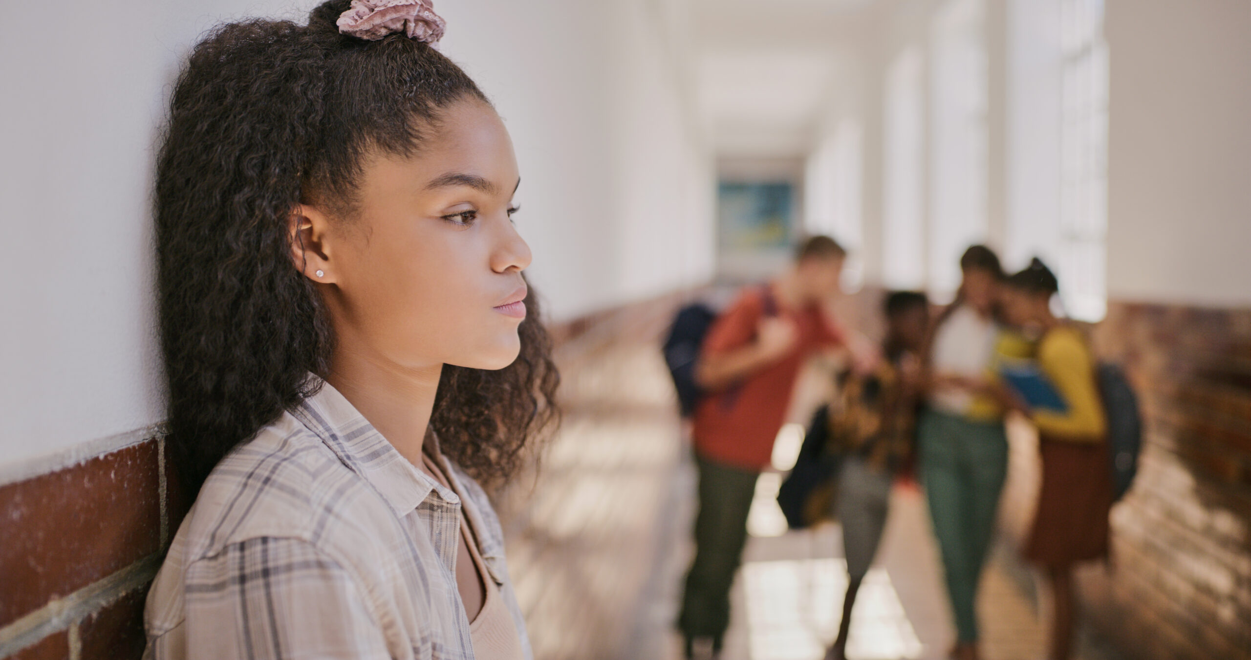 Young sad teenage girl feeling excluded at school