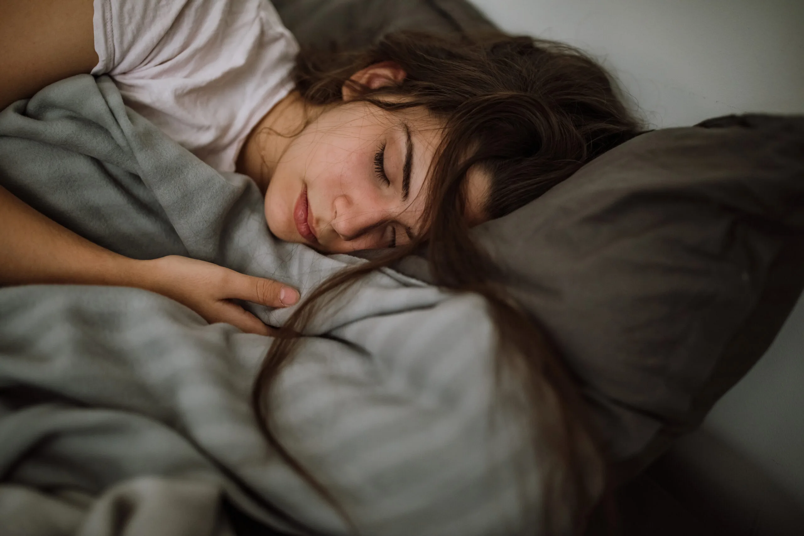 Young woman sleeping in bedroom