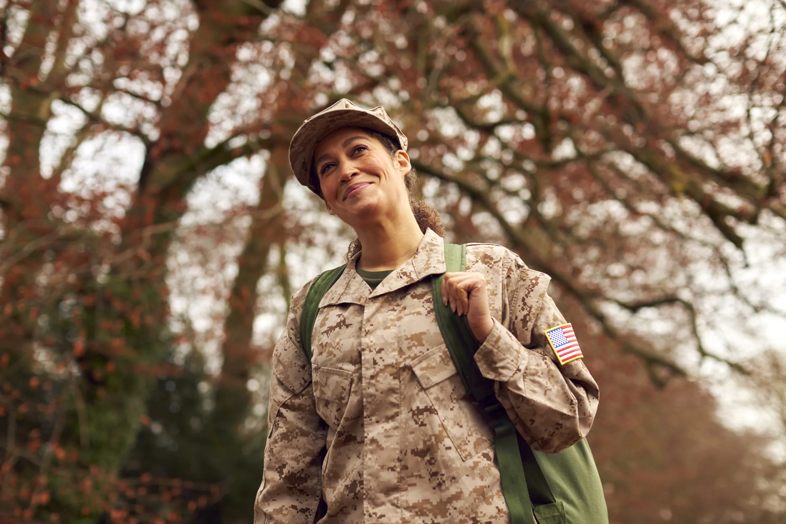 American Female Soldier In Uniform Carrying Kitbag Returning Home On Leave